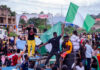 ISIS Leader Annihilation: U.S-Nigeria Strike Stuns Crowd at a rally waving a large Nigerian flag