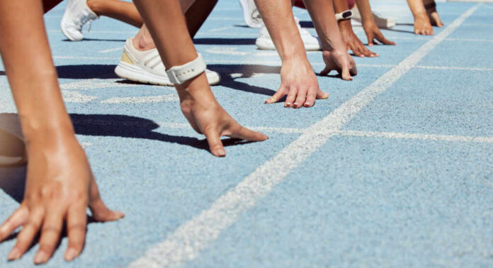 Athletes at starting line on blue track race