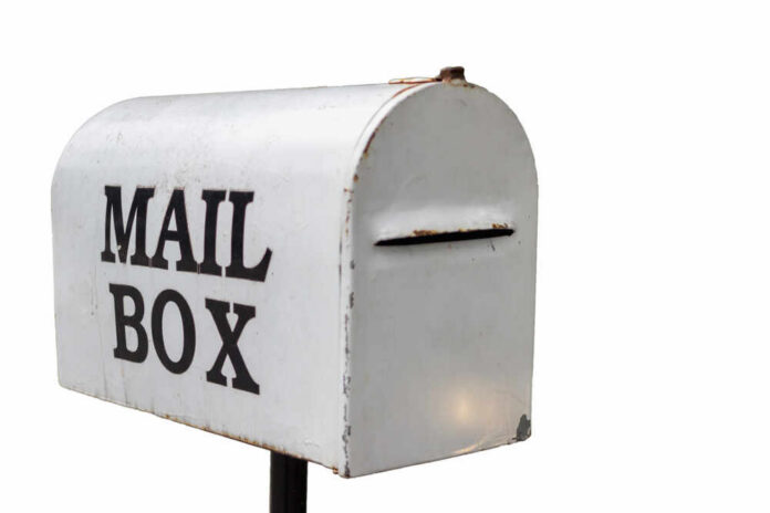 The,Old,White,Mailbox,Is,A,Vintage,Style,Mailbox,That Postal worker loading mail into a blue USPS collection box