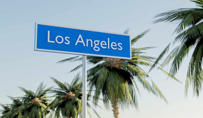 Sign indicating Los Angeles surrounded by palm trees