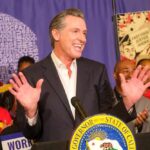 $24 Billion Question Haunts Newsom, Bass California governor speaking at a public event with supporters