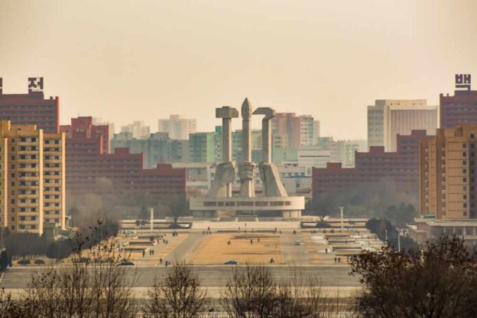 shutterstock_2513153989.jpg View of a large monument surrounded by buildings in Pyongyang