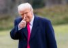 Trump’s PURGE Targets Weak Republicans A man in a dark coat and pink tie giving a thumbs up outdoors