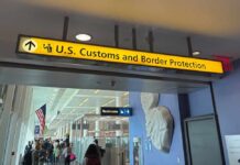 Mullin Warns Sanctuary Cities: Cooperate or Face Customs Cuts Sign for U.S. Customs and Border Protection at an airport
