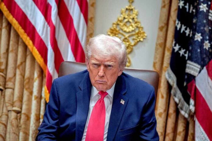 shutterstock_2711671719.jpg Donald Trump seated in the Oval Office with a serious expression