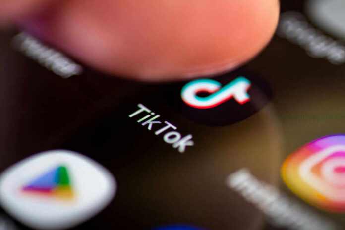 tiktok632918390jpg Finger tapping TikTok app on a smartphone screen