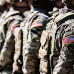 Cartel Kill List Grows — Evidence Still Missing Soldiers in camouflage with American flag patches standing