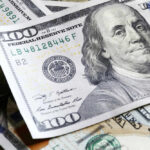De-Dollarization Drumbeat Rattles Washington Several US one hundred dollar bills