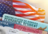 Major Green Card Overhaul Could Force Applicants to Leave U.S. Mid-Process U.S. flag with visa and permanent resident card in foreground
