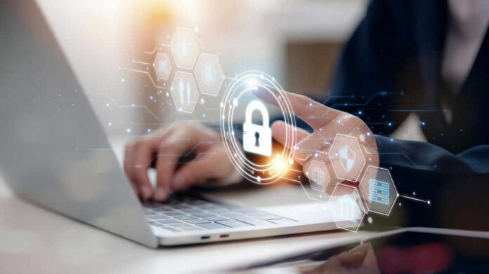 Person typing on laptop with digital security icons overlay.