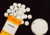 ‘Reasonable’? Millions Of Pills Waived In Prescription bottle of fentanyl tablets scattered on surface