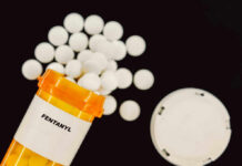 ‘Reasonable’? Millions Of Pills Waived In Prescription bottle of fentanyl tablets scattered on surface