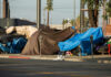 Street encampment with tarps and makeshift shelters