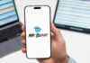 Constitutional Tripwire Stops MrBeast Mania Smartphone displaying MrBeast logo held in hand