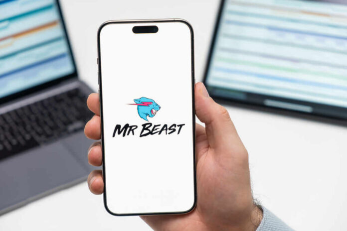mr-beast-logo-on-the-screen-of-smartphone2482129457jpg Smartphone displaying MrBeast logo held in hand