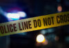 Hot Grease, Knife—Over A Takeout Mix-Up Police tape with do not cross message at night