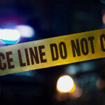 Hot Grease, Knife—Over A Takeout Mix-Up Police tape with do not cross message at night