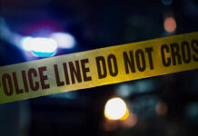 Police tape with do not cross message at night