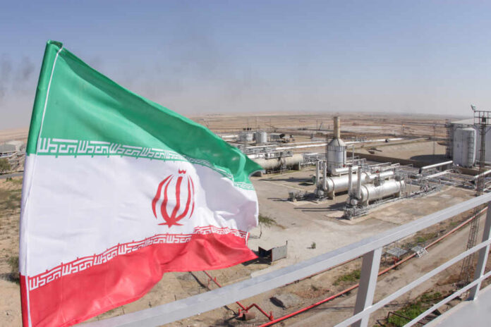 Oil,And,Gas,Refineries,/,Flag,Of,Iran Iranian flag waving in front of an oil processing facility
