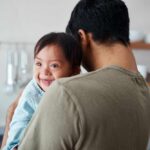 Parents Push Back on Down Syndrome Abortions Person holding a plastic female reproductive system model