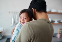 Parents Push Back on Down Syndrome Abortions Person holding a plastic female reproductive system model