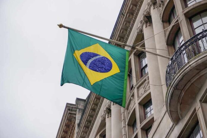 Brazilian,Flag,Outside,Official,Building,In,City.,Flag,Of,Brazil A hand holding a smartphone displaying a severe weather alert against a stormy background