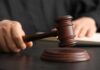 33 Years: Judge Shocks Political Darling A judge's hand holding a gavel above a wooden block