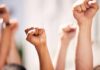 Students Flood the Streets — Jakarta Erupts in Protest Multiple raised fists in a show of solidarity during a protest