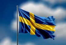 Open Borders Myth Shattered In Sweden Waving flag of Sweden against a blue sky