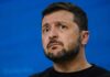Trump, Zelenskyy Praise “Great” Call — But Where’s the Deal? Man speaking at a podium with microphone