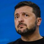 Trump, Zelenskyy Praise “Great” Call — But Where’s the Deal? Man speaking at a podium with microphone