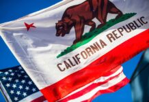 Mega-Tunnel Madness Hits World Heritage Park California Republic flag waving alongside the American flag against a blue sky
