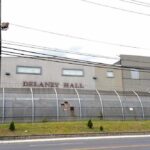Governor Stonewalled—What’s Inside Delaney Hall? Detention facility behind barbed-wire fence along a street
