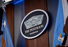 War Powers Meltdown: Who’s Really In Charge? The Pentagon emblem between two flags.