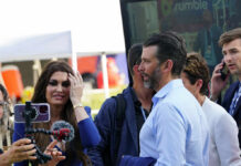 Live-Stream Death Vow Targets Trump Jr. Group of people talking at an outdoor event