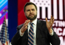 Atlantic Revives Vance Attack—Backfires? Man in suit speaking on stage with gesturing hands