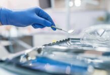 Predator Exploits Dental Loophole Gloved hand holding a dental mirror over instrument tray