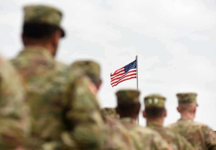 U.S. flag flying above a formation of soldiers in uniform