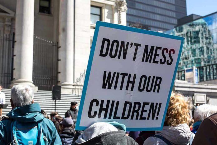 shutterstock_1953475393 protest sign held in a crowd outside a government building