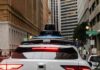 Inside Waymo’s Eye: Safety Win Or Surveillance Trap? Rear view of a Waymo autonomous vehicle on a city street