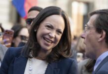 Stability Deal? Trump Dumps Venezuela Dissident A woman smiling while engaging in conversation at a public event