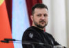 Zelensky’s Winter Bet: Oil Fixer Now Prime Minister man in black sweatshirt at a podium looking to the side