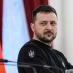 Zelensky’s Winter Bet: Oil Fixer Now Prime Minister man in black sweatshirt at a podium looking to the side