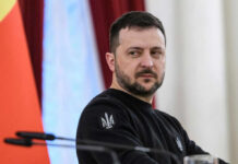 Zelensky’s Winter Bet: Oil Fixer Now Prime Minister man in black sweatshirt at a podium looking to the side