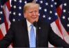 Ballot Fight Erupts: Trump Votes By Mail man at podium with U.S. flags behind him