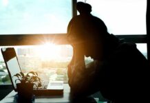 Silent Surge Among Veterans — Why Now? silhouetted person at a desk with head in hands