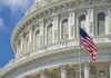 American flag before ornate neoclassical capitol building