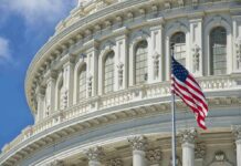 Toss-Up Turmoil: Lawler’s Seat Turns Volatile American flag before ornate neoclassical capitol building