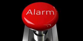 Red alarm button on a metallic base