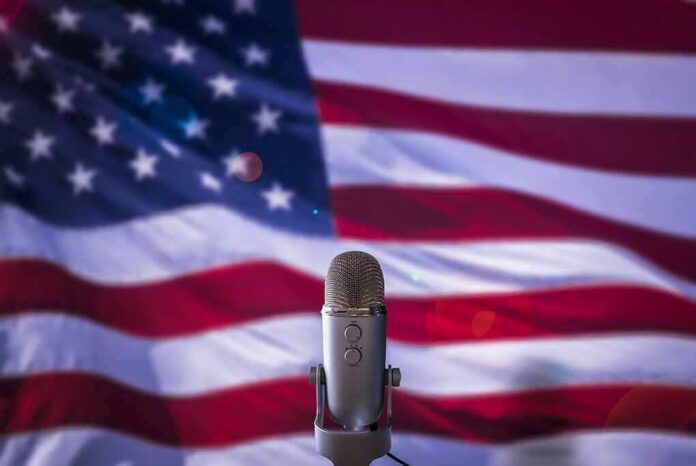 Microphone in front of an American flag backdrop